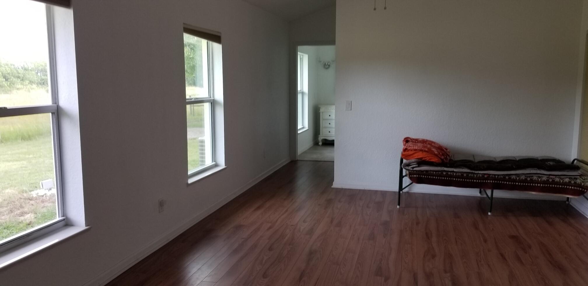 5425 Koblegard Road Fort Pierce, FL 34951 - Photo 22 of 33 an empty room with wooden floor and windows