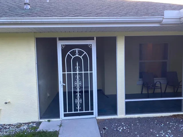 a kitchen with granite countertop a sink and a refrigerator