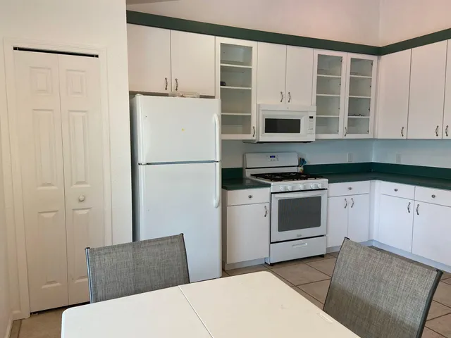 a kitchen with stainless steel appliances a refrigerator sink and cabinets