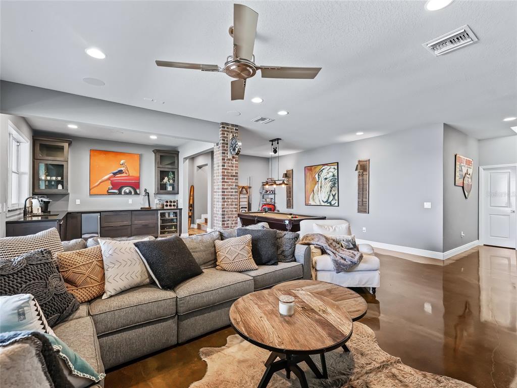 12943 Southeast Sunset Harbor Road Weirsdale, FL 32195 - Photo 57 of 87 a living room with furniture kitchen view and a large window