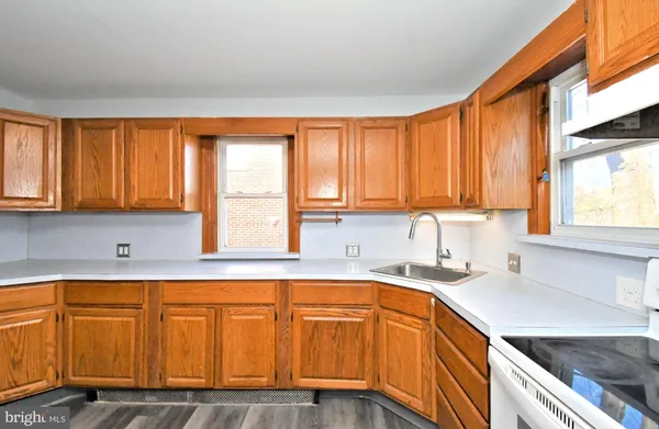 a kitchen with wooden cabinets and a sink