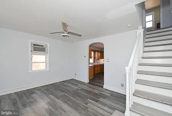 a view of entryway and hall with wooden floor