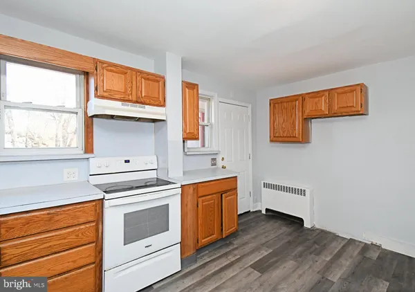 a kitchen with granite countertop white cabinets and white appliances