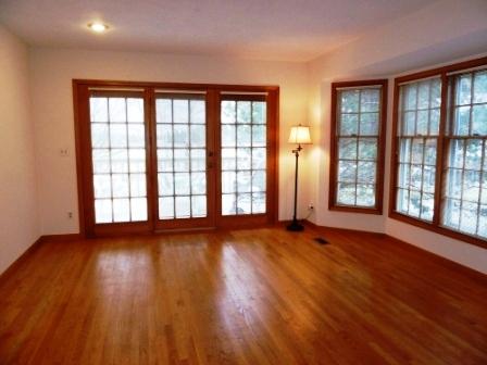 2618 Miller Road Geneva, IL 60134 - Photo 7 of 16 a view of an empty room with wooden floor and a window