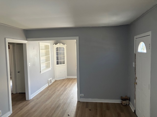 17821 Roy Street Lansing, IL 60438 - Photo 6 of 17 an empty room with wooden floor and windows