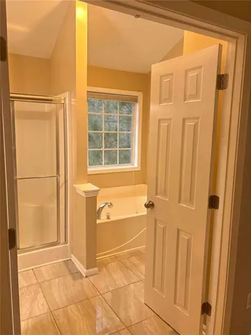 a bathroom with a tub and shower