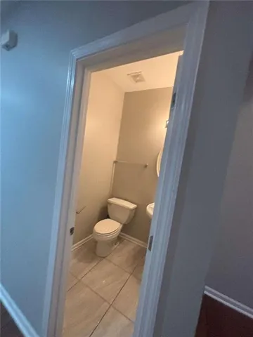 a bathroom with a toilet a sink and a vanity