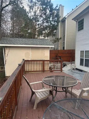 a view of a chairs and table on the roof deck