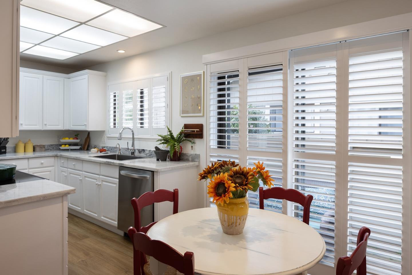 3850 Rio Road, Unit 63 Carmel, CA 93923 - Photo 8 of 19 a dining room with furniture a large window and wooden floor