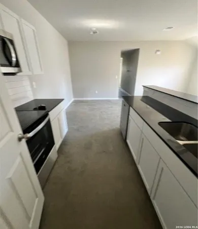 a kitchen with a stove and a microwave
