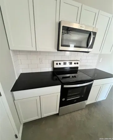 a kitchen with a stove and a microwave