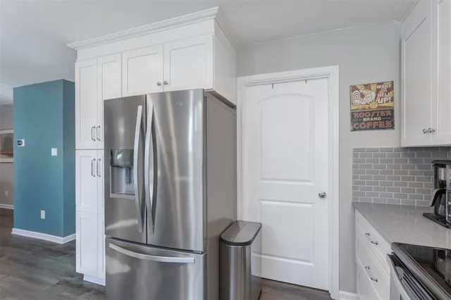 a kitchen with stainless steel appliances a refrigerator and a stove top oven
