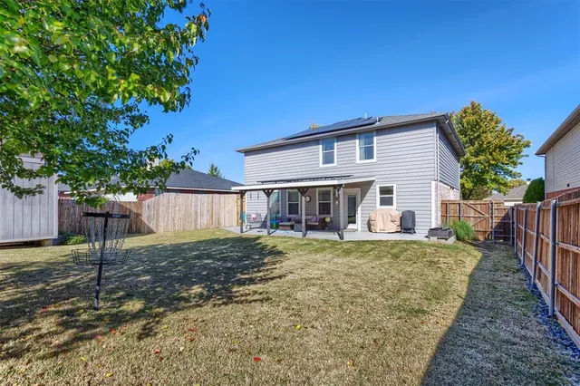 a view of a house with a yard and deck