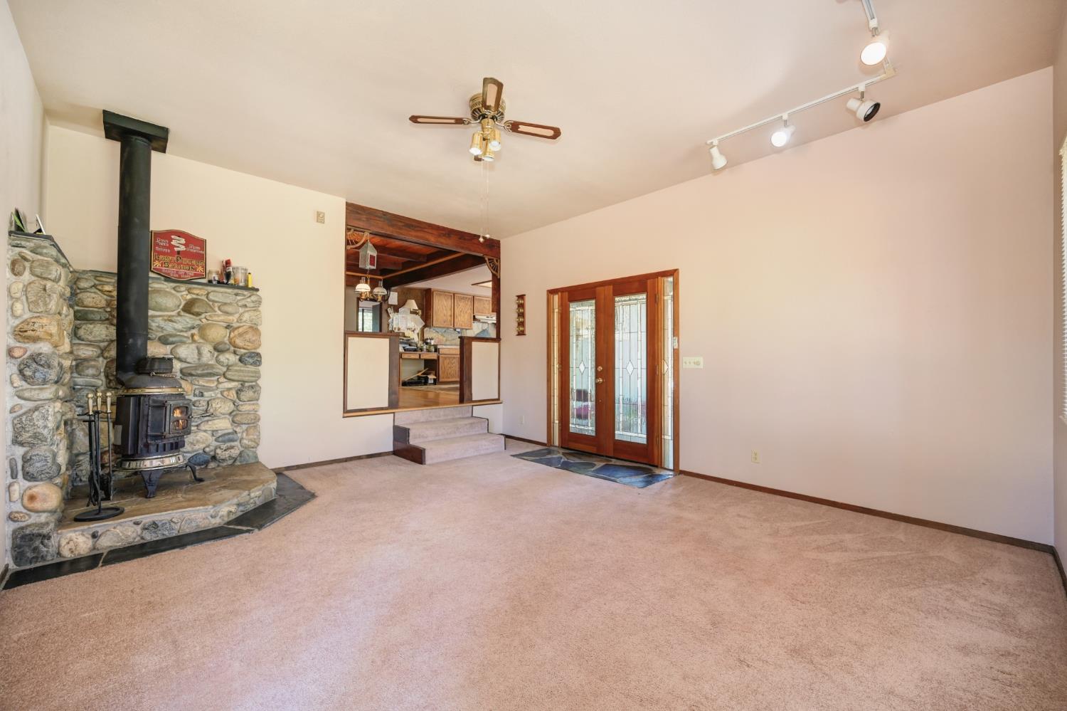 15310 Tyler Foote Road Nevada City, CA 95959 - Photo 11 of 63 an empty room with fireplace and fan