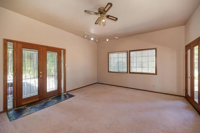 a living room with furniture kitchen and a wooden floor