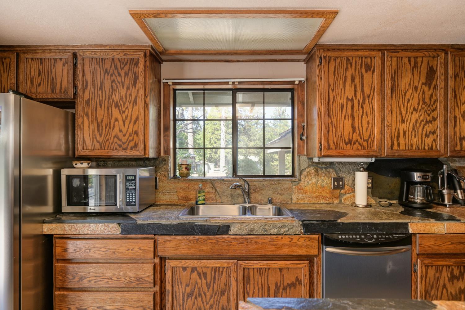 15310 Tyler Foote Road Nevada City, CA 95959 - Photo 19 of 63 a kitchen with stainless steel appliances granite countertop a stove and a refrigerator