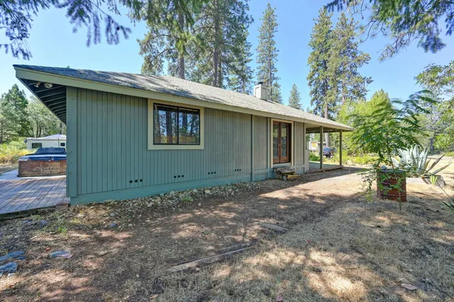 a view of a patio with table and chairs under an umbrella