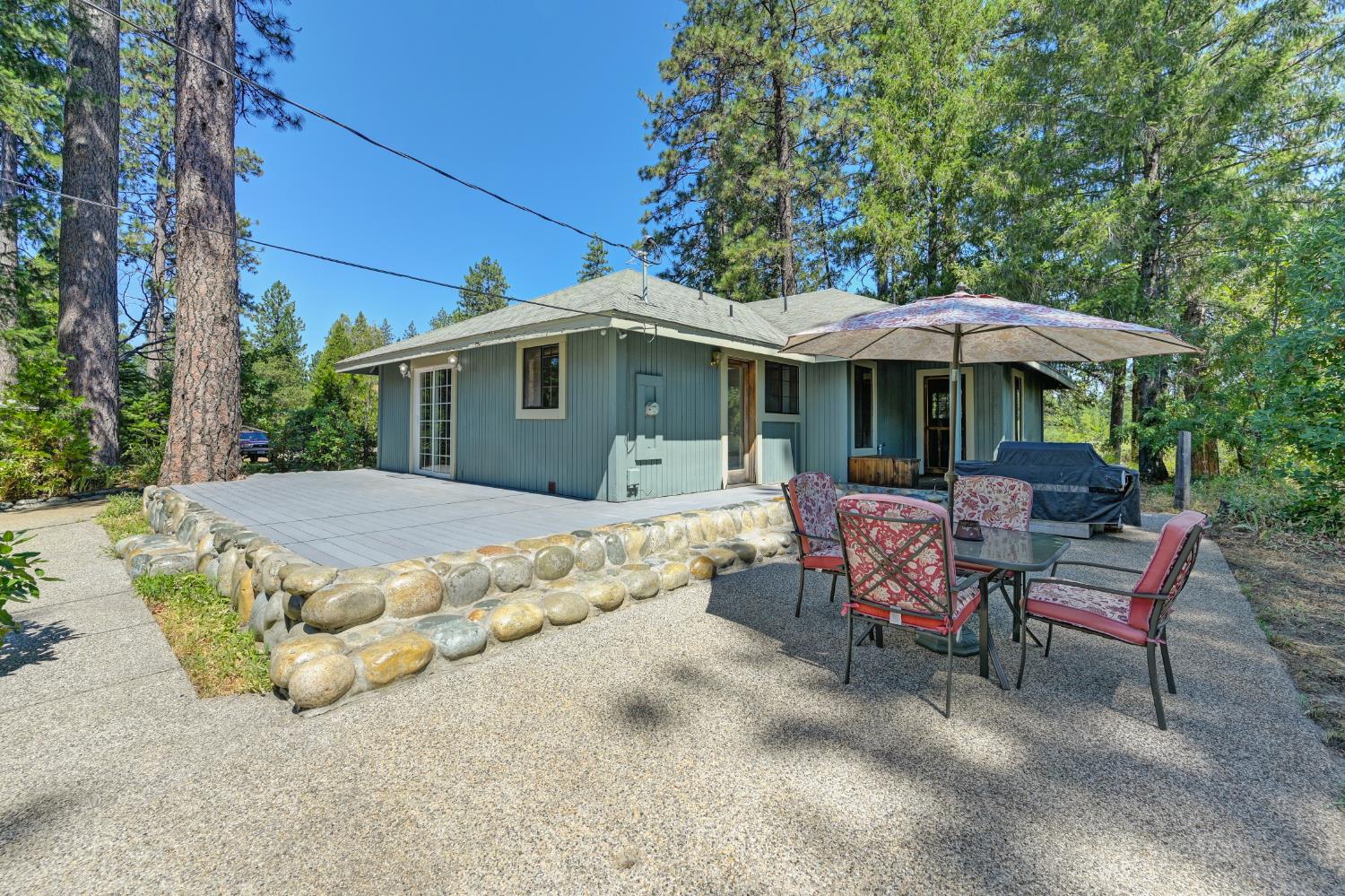 15310 Tyler Foote Road Nevada City, CA 95959 - Photo 41 of 63 a view of a patio with table and chairs under an umbrella