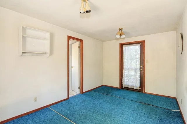a view of a livingroom with furniture and a window