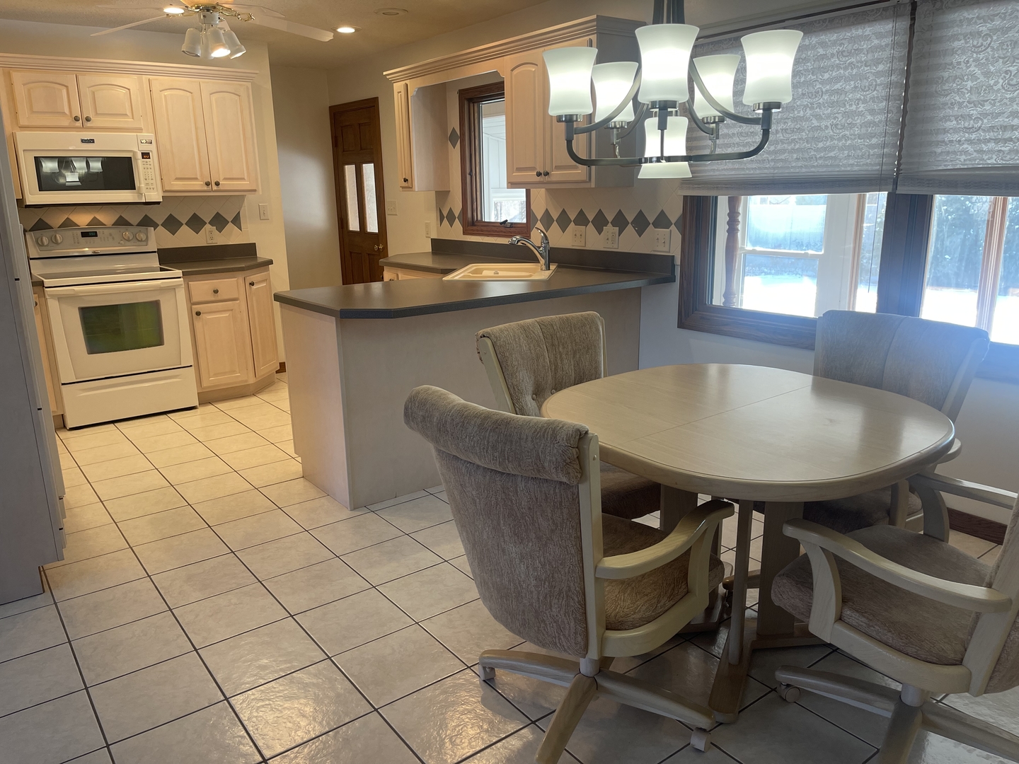 1308 Sunset Drive Peru, IL 61354 - Photo 3 of 19 a kitchen with cabinets and chairs