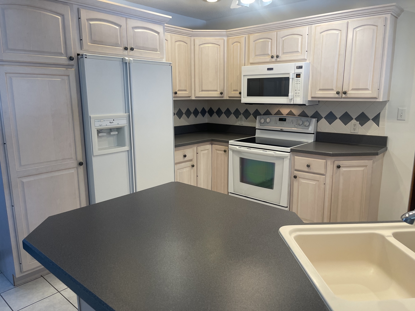 1308 Sunset Drive Peru, IL 61354 - Photo 5 of 19 a kitchen with stainless steel appliances a refrigerator stove microwave and sink