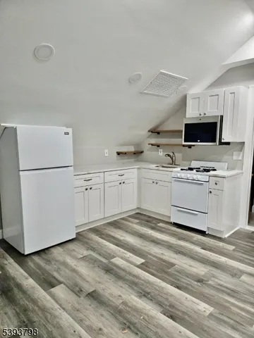 a kitchen with stainless steel appliances granite countertop a refrigerator sink and white stove