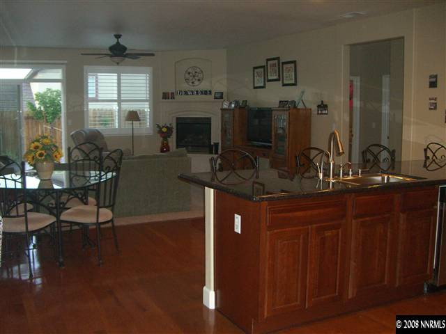 10823 Rushing Flume Drive Reno, NV 89521 - Photo 2 of 9 a kitchen with a table chairs and a wooden floor