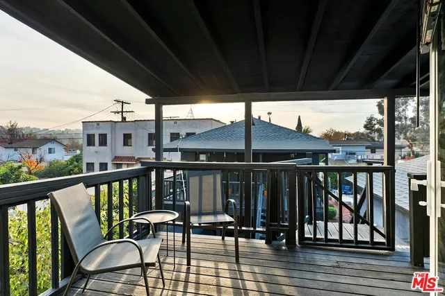a view of a patio with a table and chairs under an umbrella