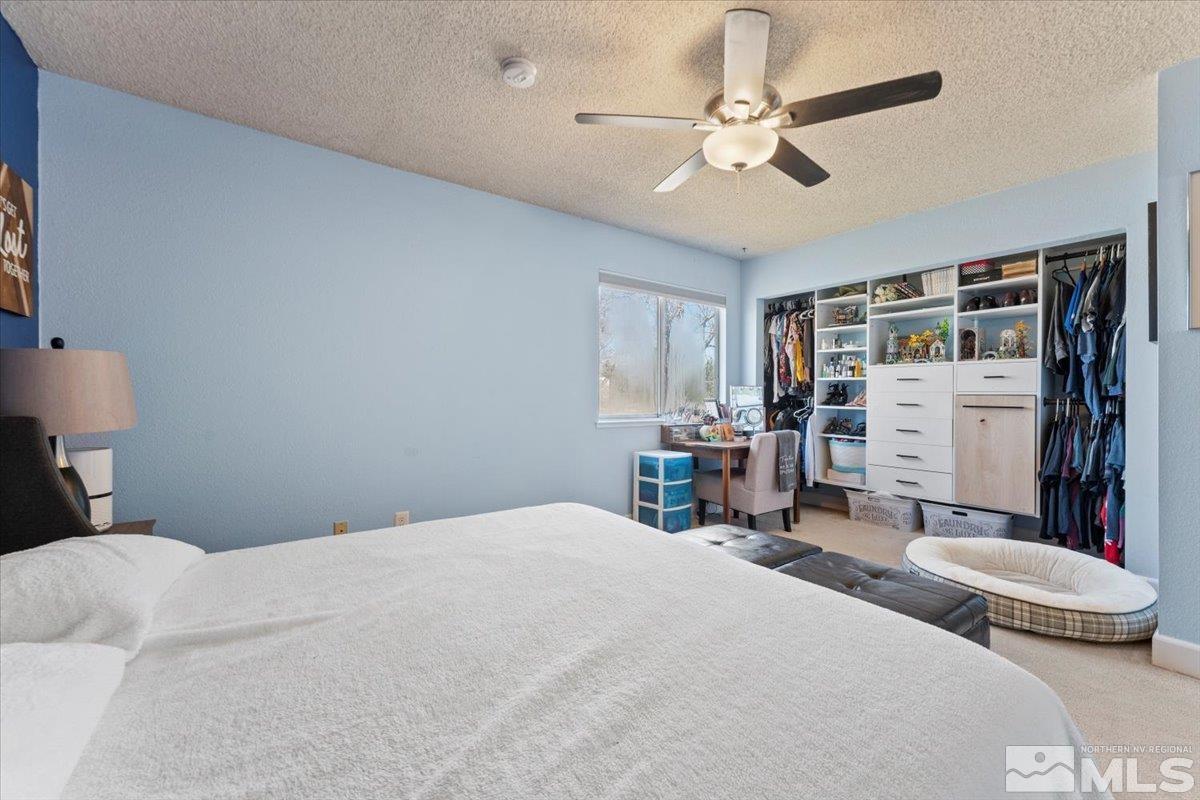 4435 Perro Lane Reno, NV 89502 - Photo 15 of 35 a bedroom with a bed a table and chair