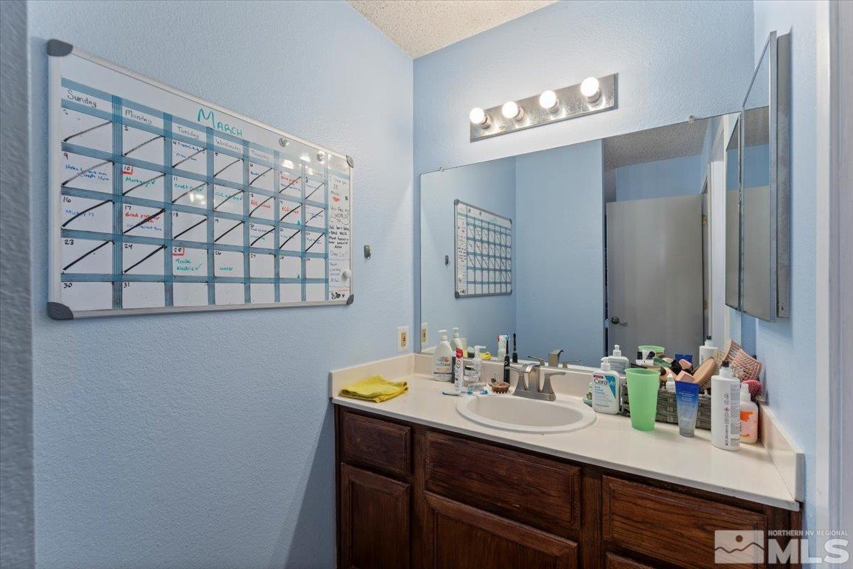 4435 Perro Lane Reno, NV 89502 - Photo 16 of 35 a bathroom with a sink vanity and a mirror