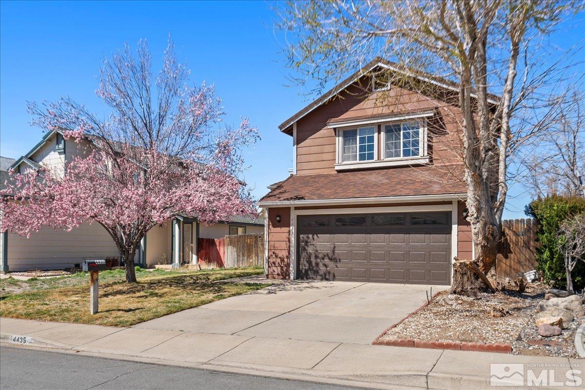 4435 Perro Lane Reno, NV 89502 - Photo 2 of 35 a front view of a house with garage and plants