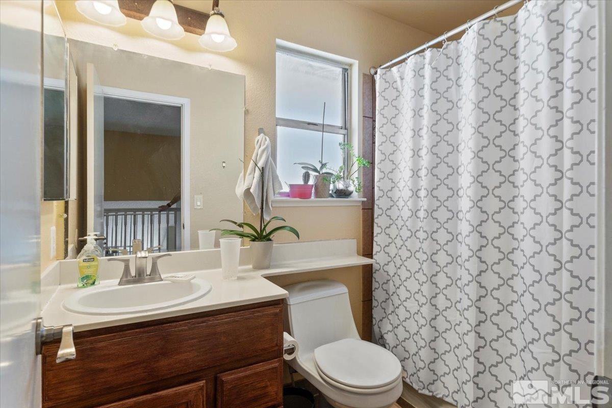 4435 Perro Lane Reno, NV 89502 - Photo 22 of 35 a bathroom with a sink a toilet and a mirror