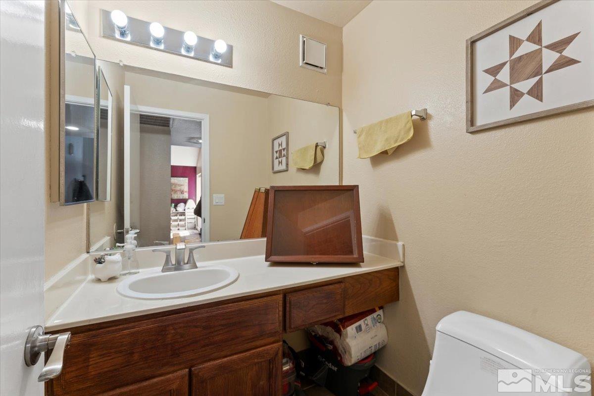 4435 Perro Lane Reno, NV 89502 - Photo 23 of 35 a bathroom with a sink toilet and mirror