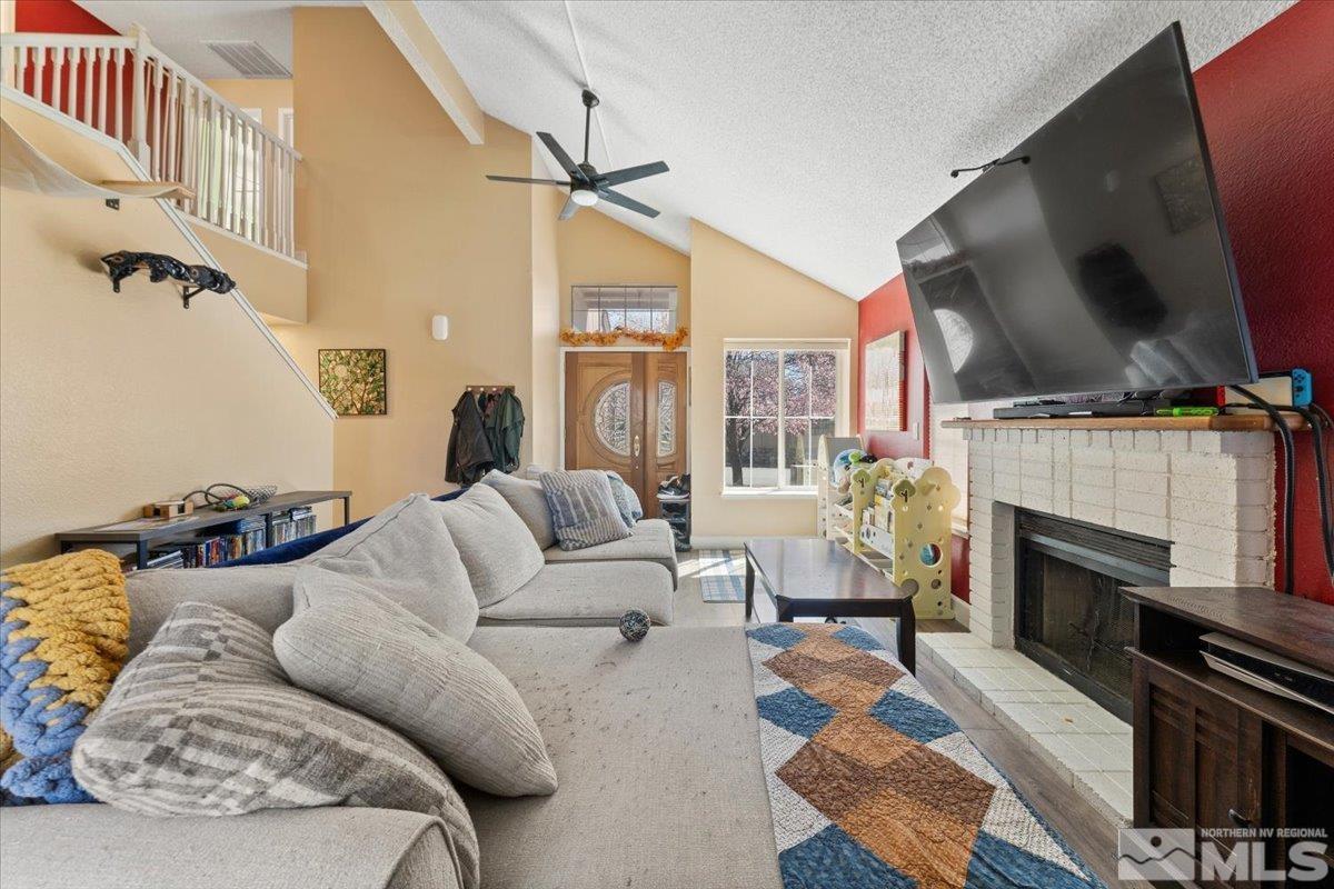 4435 Perro Lane Reno, NV 89502 - Photo 6 of 35 a living room with furniture fireplace and a flat screen tv