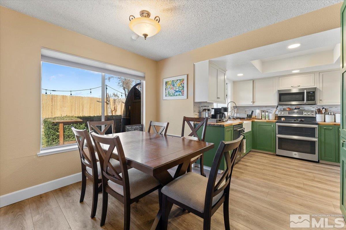 4435 Perro Lane Reno, NV 89502 - Photo 7 of 35 a view of a dining room with furniture and wooden floor