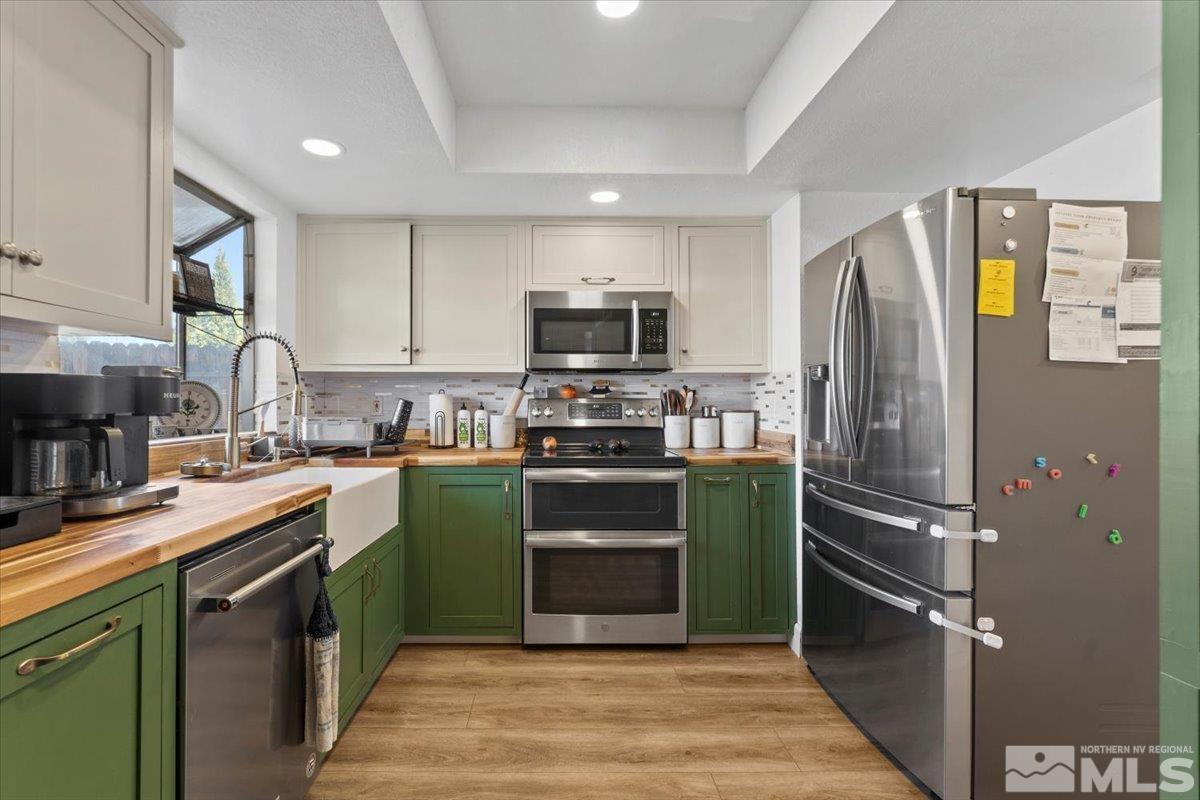 4435 Perro Lane Reno, NV 89502 - Photo 9 of 35 a kitchen with a sink stainless steel appliances and cabinets