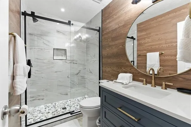 a bathroom with a sink toilet and shower