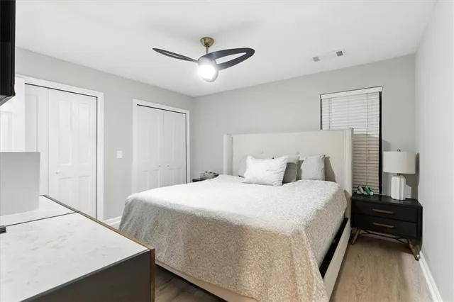 a bedroom with a bed and a ceiling fan