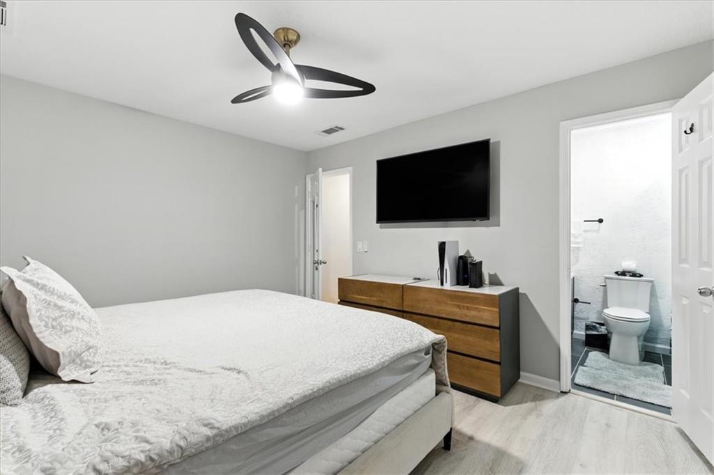 1524 Springleaf Circle Southeast Smyrna, GA 30080 - Photo 13 of 20 a bedroom with a bed and a flat screen tv