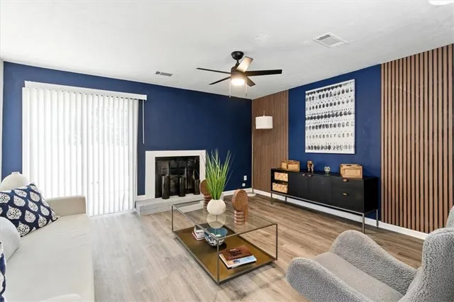 a living room with furniture and a fireplace