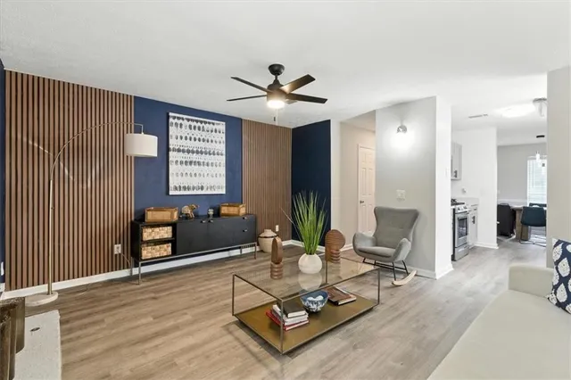 a living room with furniture and wooden floor