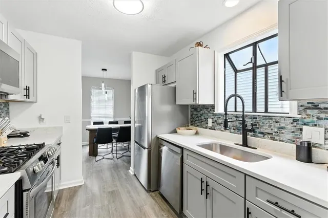 a kitchen with a sink stove and cabinets
