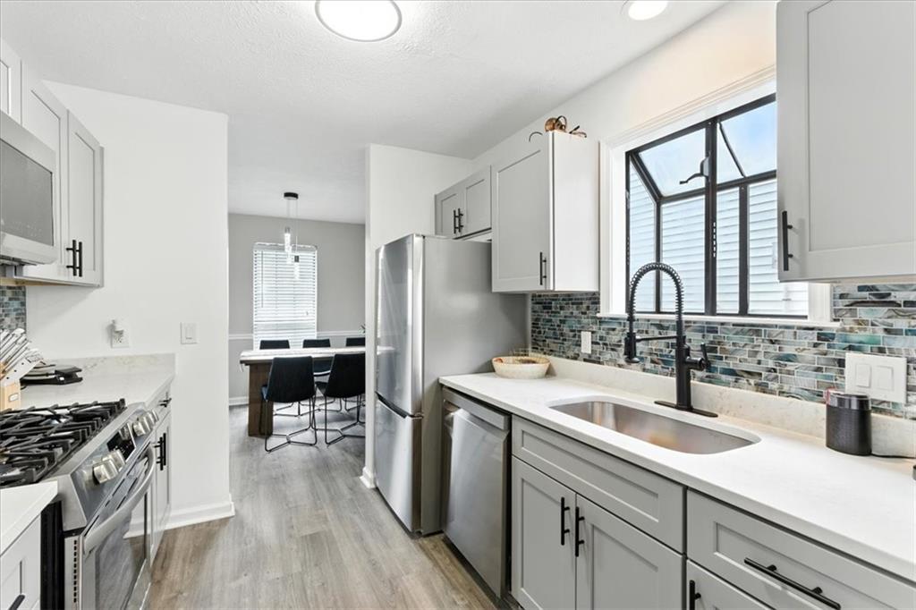 1524 Springleaf Circle Southeast Smyrna, GA 30080 - Photo 5 of 20 a kitchen with a sink stove and cabinets