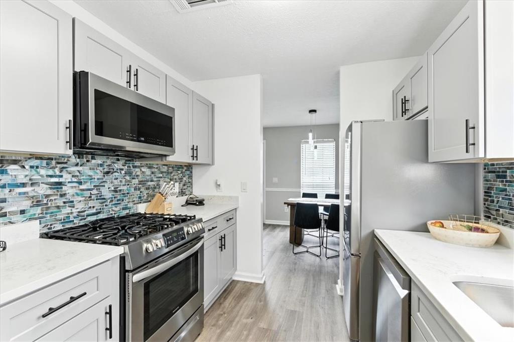 1524 Springleaf Circle Southeast Smyrna, GA 30080 - Photo 6 of 20 a kitchen with a stove and a microwave