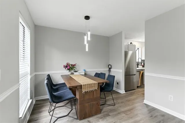 a view of a dining room with furniture and a chandelier