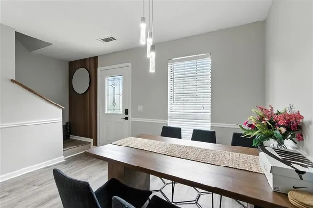 a dining room with furniture and wooden floor