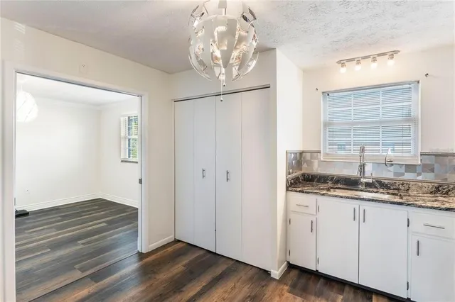 a kitchen with kitchen island a counter top space stainless steel appliances and cabinets