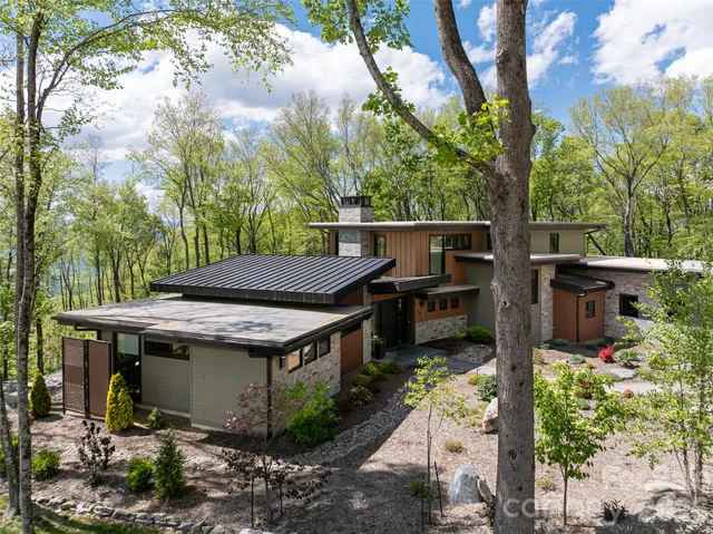 a front view of a house with swimming pool and patio