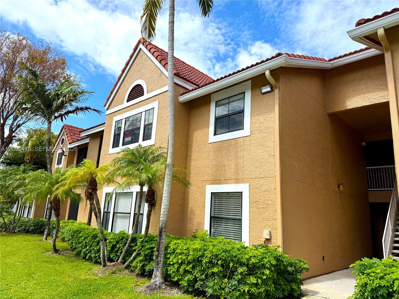 10440 Southwest 156th Court, Unit 712 Miami, FL 33196 - Photo 1 of 10 a front view of a house with a yard