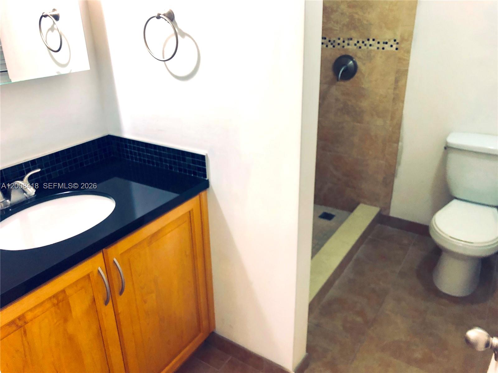 10440 Southwest 156th Court, Unit 712 Miami, FL 33196 - Photo 5 of 10 a bathroom with a sink and a mirror